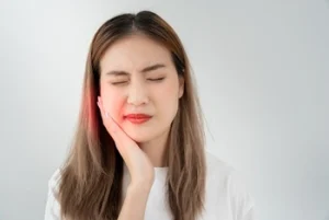 patient holding cheek showing signs of pain patient holding cheek showing signs of pain